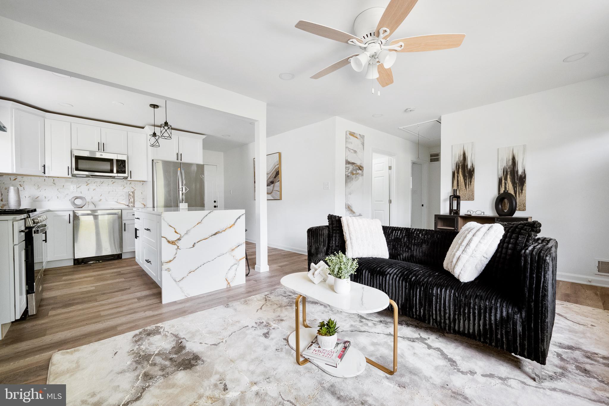 6907 Kipling Parkway District Heights, MD 20747 - Photo 9 of 39 a living room with furniture a rug and kitchen view