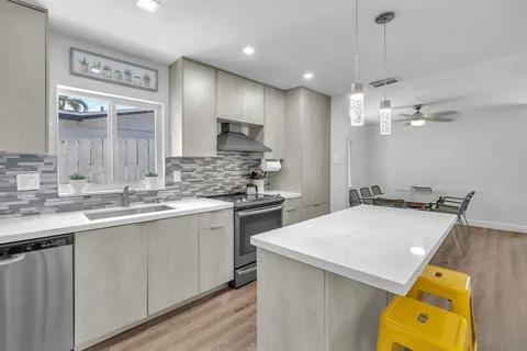 a kitchen with a sink appliances and cabinets
