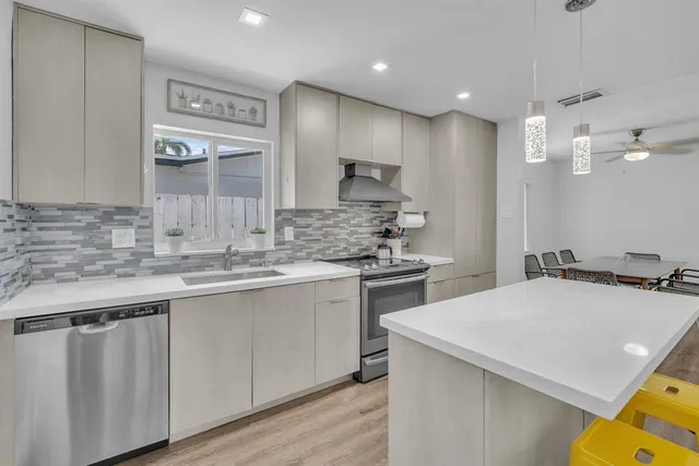 a kitchen with a sink cabinets and wooden floor