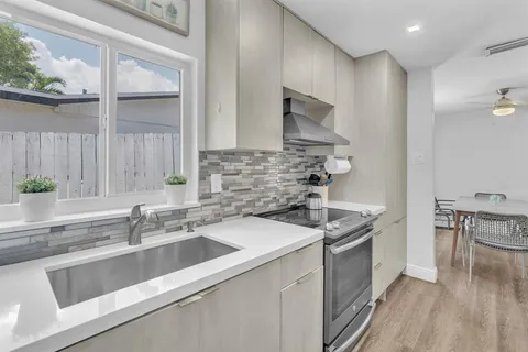 a kitchen that has a sink and a stove in it