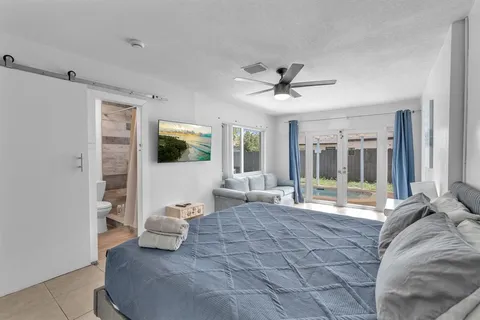 a living room with furniture and large windows