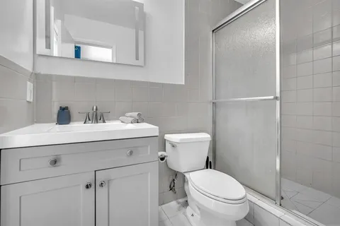 a bathroom with a sink toilet and shower