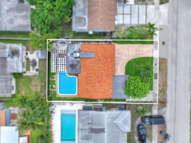 a bird view of house with a yard and outdoor seating