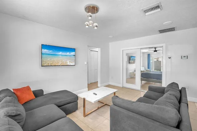 a living room with furniture and a chandelier