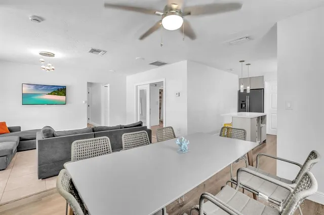 a view of a dining room with furniture and wooden floor