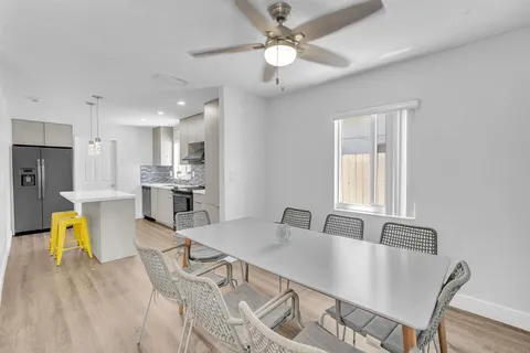 a view of a dining room with furniture and a chandelier