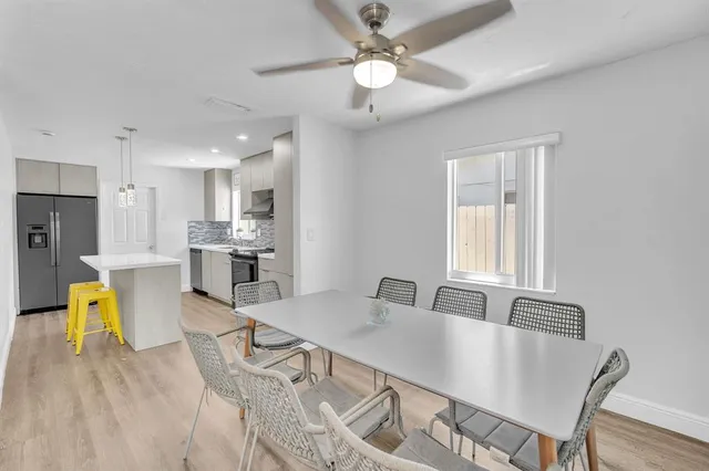 a view of a dining room with furniture and a chandelier