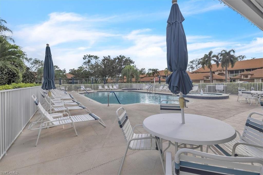 8075 Tiger Cove, Unit 1706 Naples, FL 34113 - Photo 41 of 50 Community pool featuring a patio
