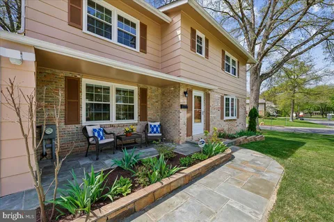 a view of a house with backyard sitting area and garden