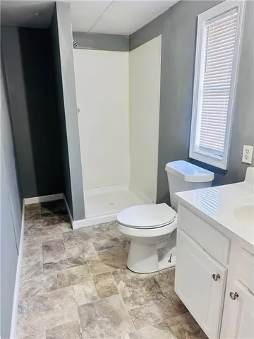 a bathroom with a toilet a sink and a mirror