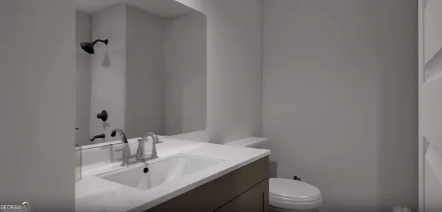 a bathroom with a sink toilet and vanity
