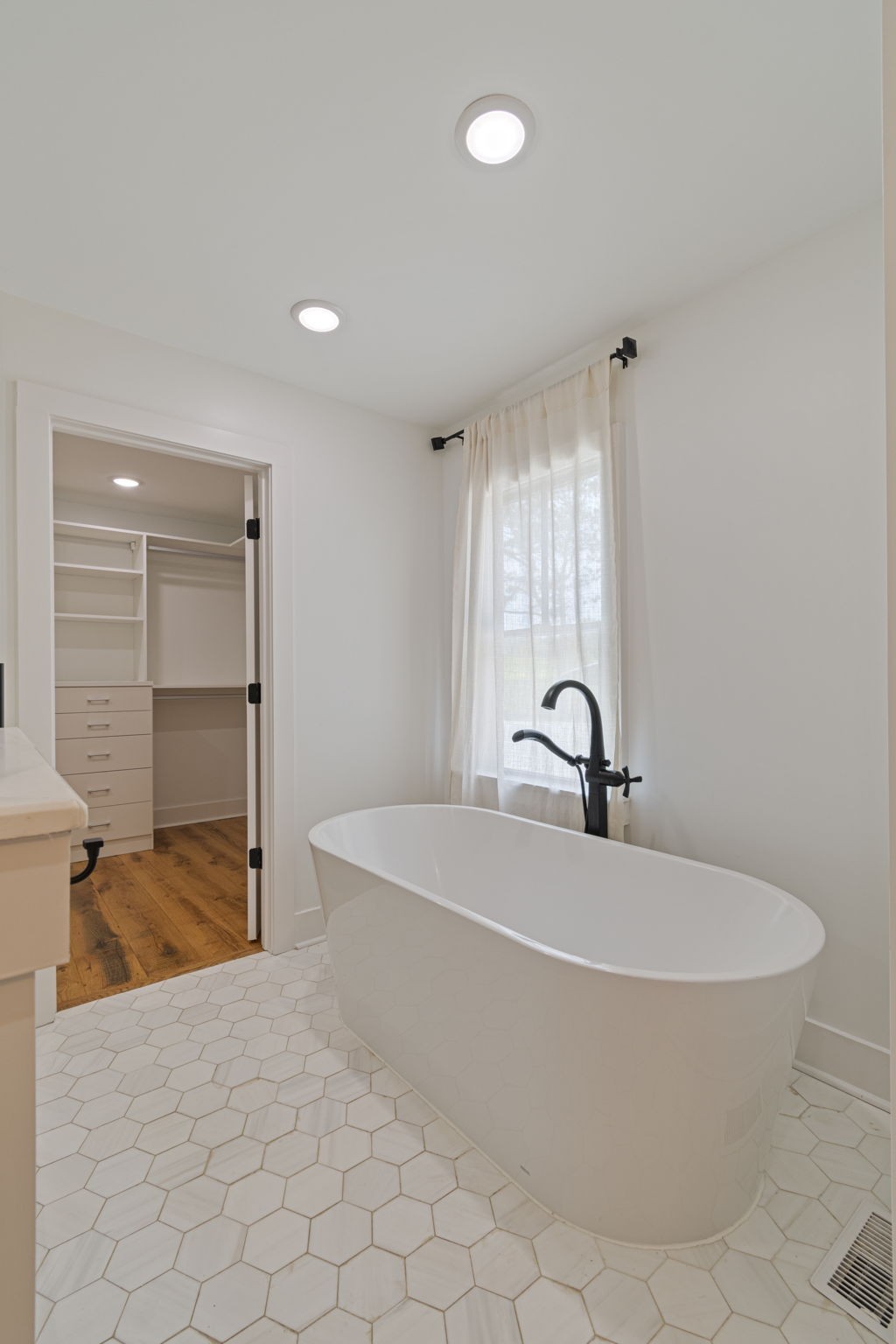 4824 Leipers Creek Road Williamsport, TN 38487 - Photo 14 of 34 a white bath tub sitting in a en suite bathroom