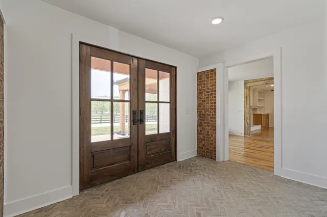 an empty room with windows closet and bathroom