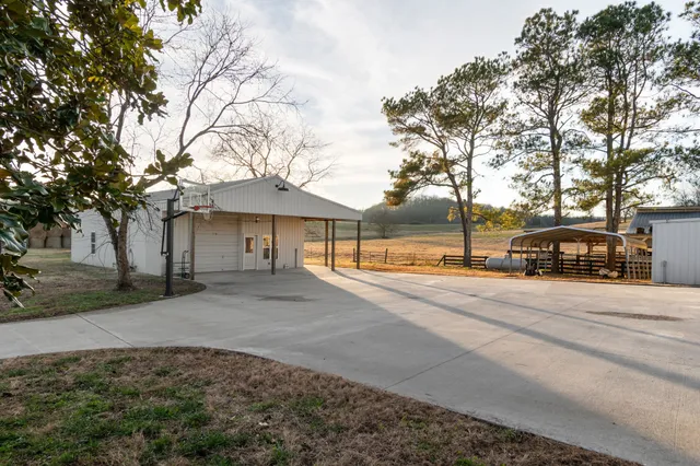 a front view of a house with a garden and parking