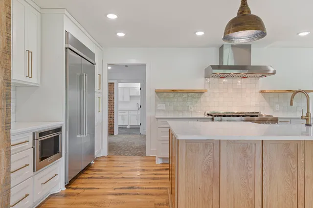 a kitchen with stainless steel appliances granite countertop a stove and a refrigerator