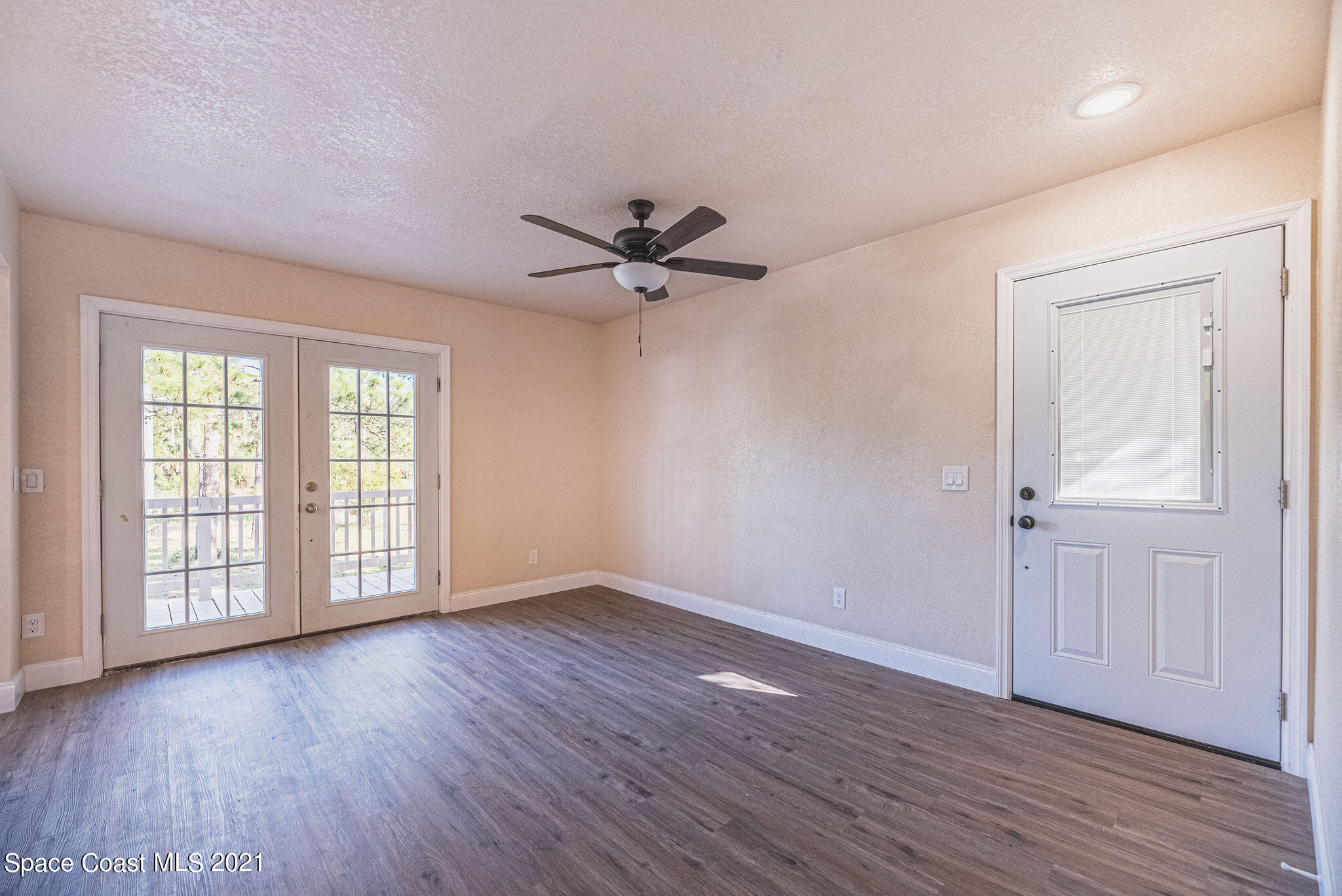 765 Garvey Road Palm Bay, FL 32908 - Photo 11 of 81 a view of an empty room with wooden floor and a window