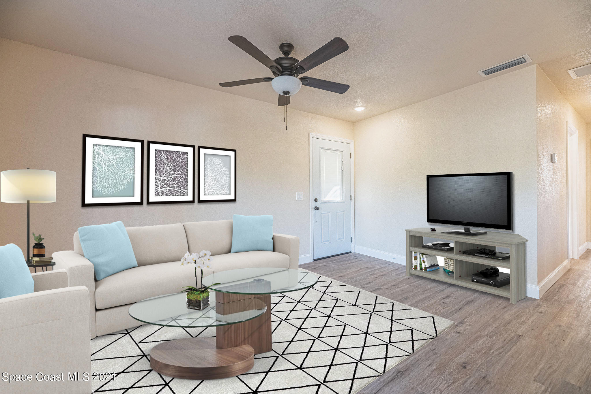 765 Garvey Road Palm Bay, FL 32908 - Photo 12 of 81 a living room with furniture and a flat screen tv with wooden floor