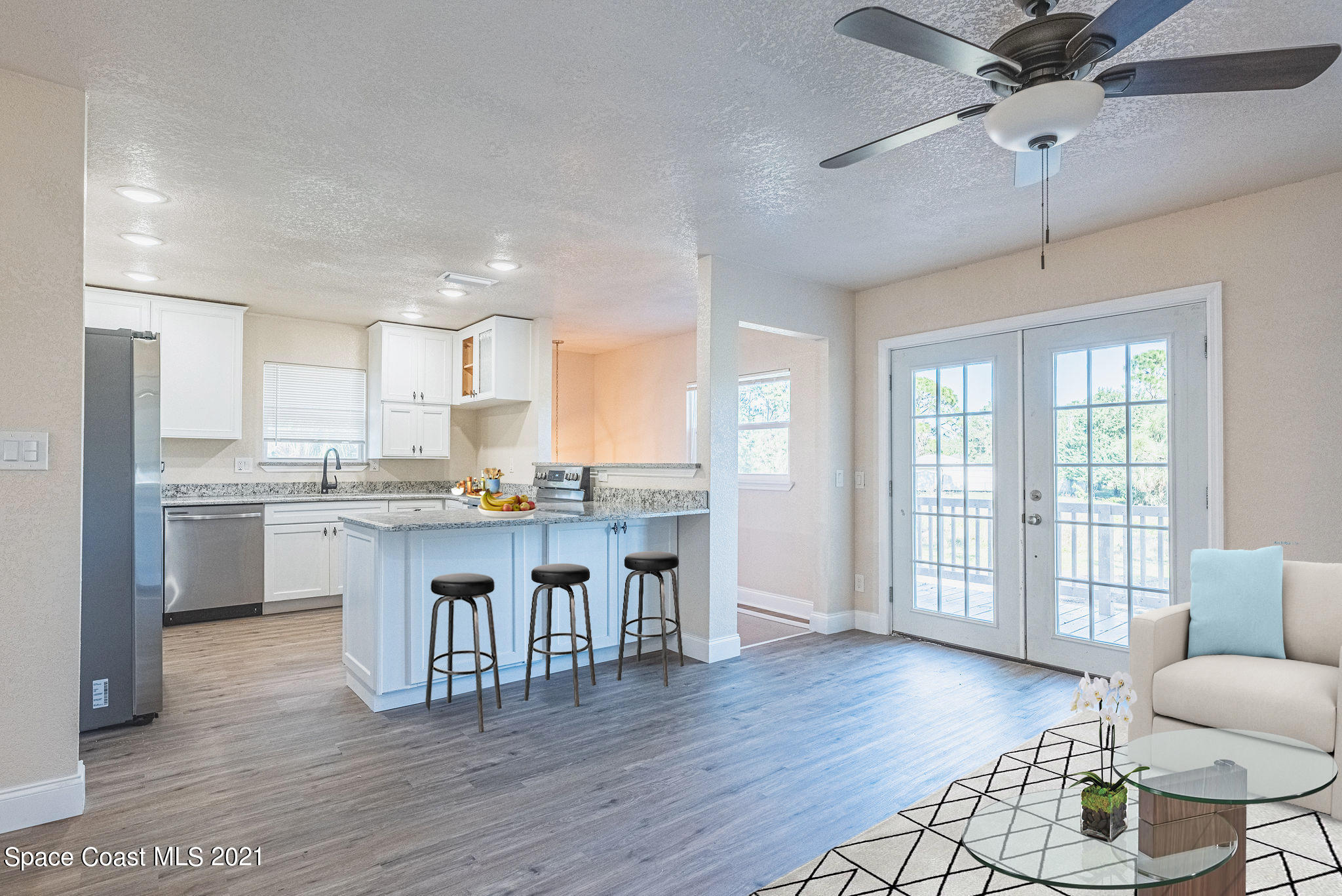 765 Garvey Road Palm Bay, FL 32908 - Photo 14 of 81 a kitchen with kitchen island granite countertop a sink cabinets and wooden floor