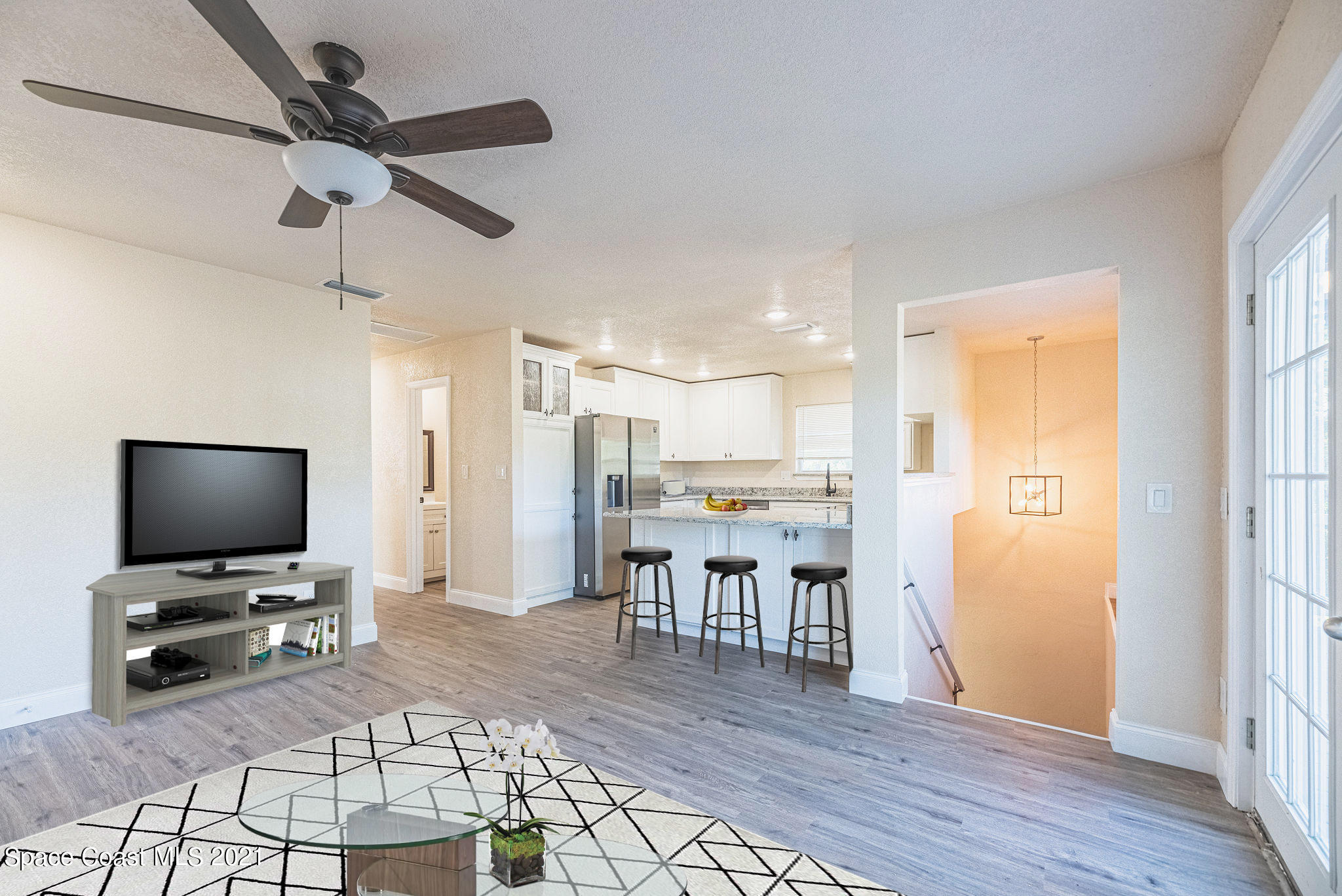 765 Garvey Road Palm Bay, FL 32908 - Photo 16 of 81 a view of a livingroom with furniture and a flat screen tv