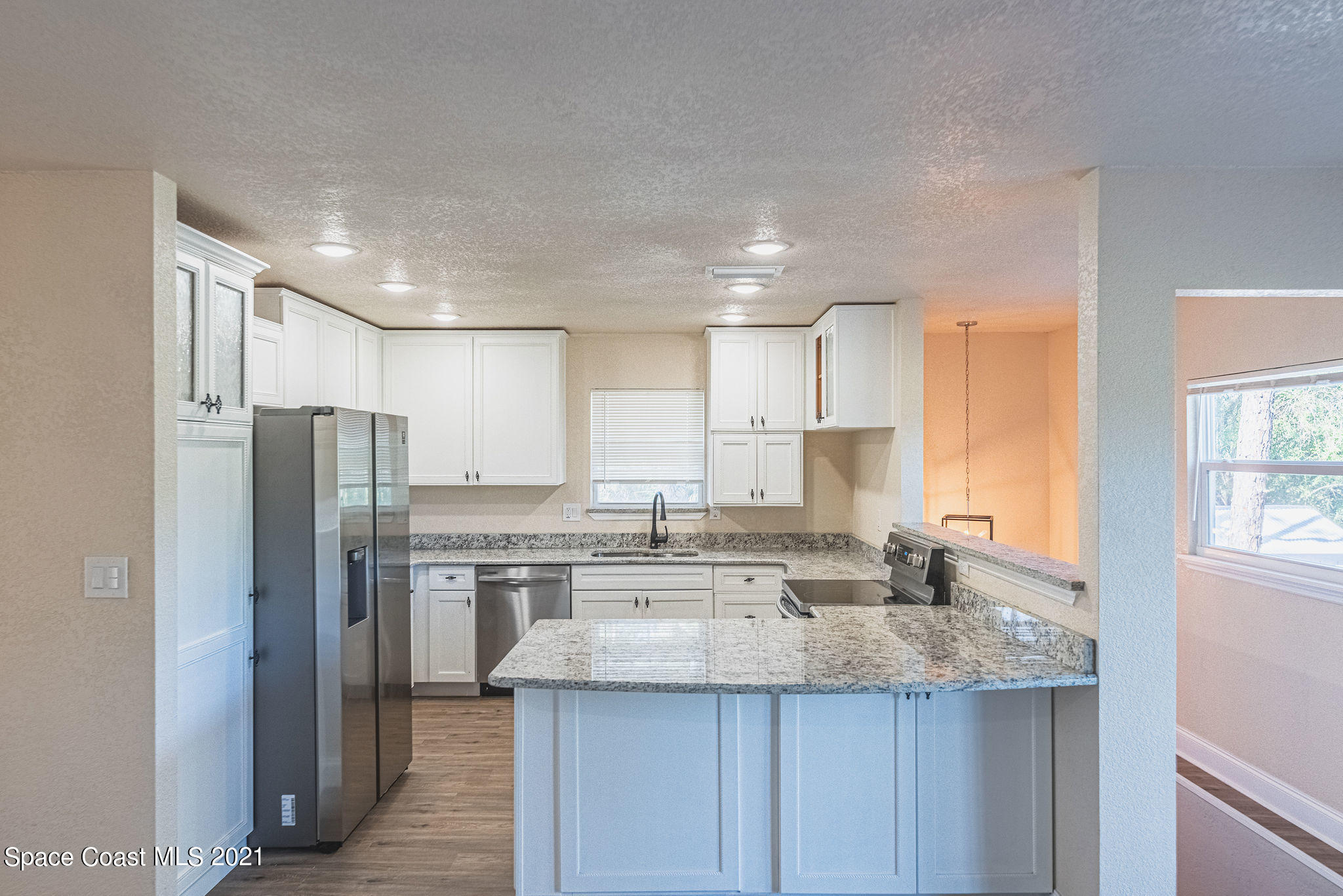 765 Garvey Road Palm Bay, FL 32908 - Photo 18 of 81 a kitchen with stainless steel appliances granite countertop a sink and a refrigerator