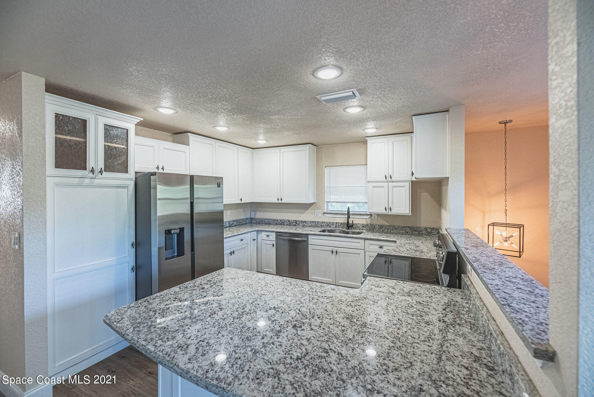 765 Garvey Road Palm Bay, FL 32908 - Photo 19 of 81 a kitchen with stainless steel appliances granite countertop a refrigerator and a sink