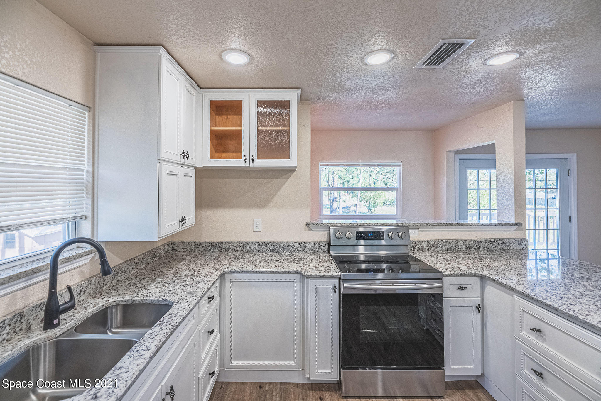 765 Garvey Road Palm Bay, FL 32908 - Photo 22 of 81 a kitchen with granite countertop a sink stainless steel appliances and window