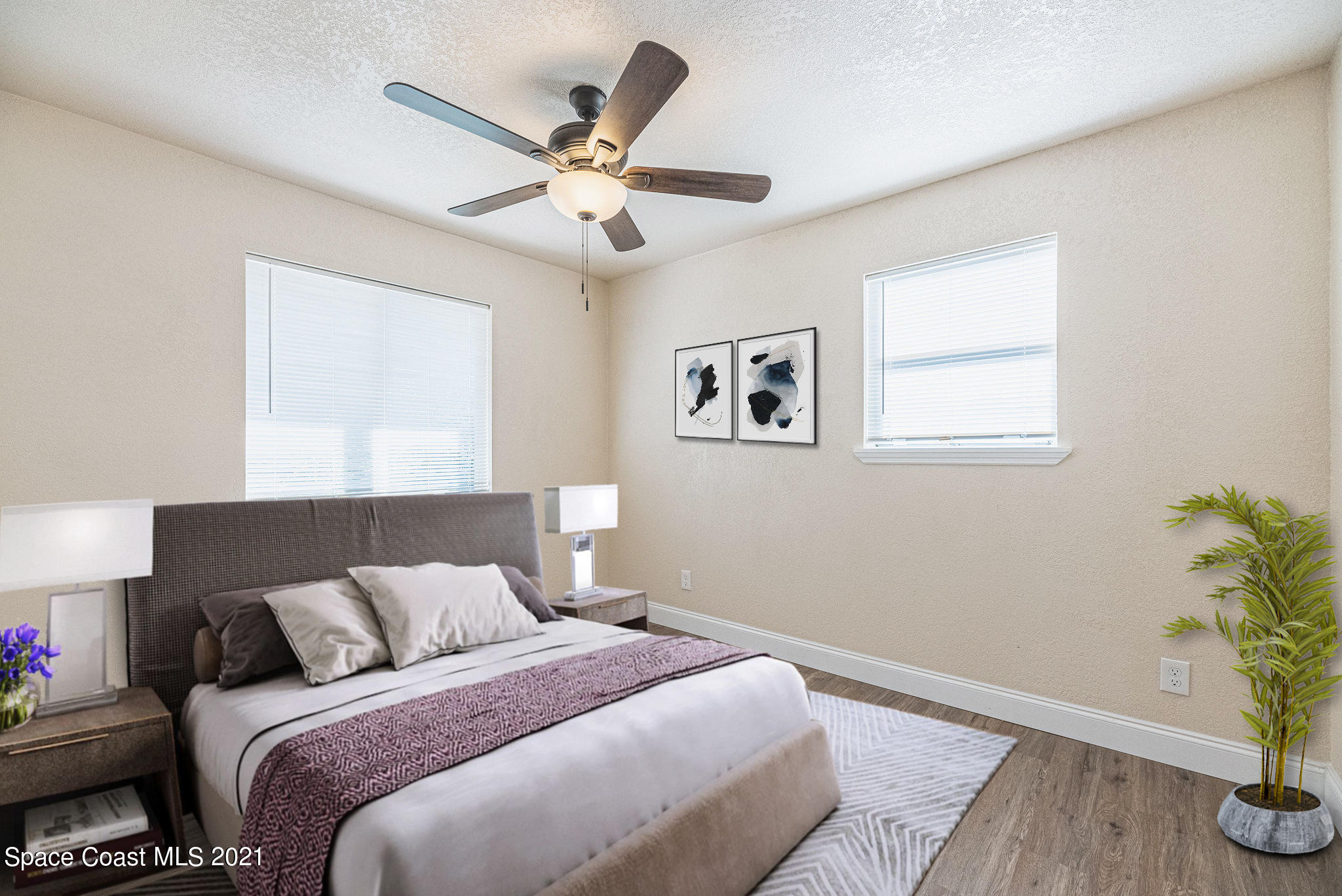765 Garvey Road Palm Bay, FL 32908 - Photo 34 of 81 a bedroom with a bed and a potted plant