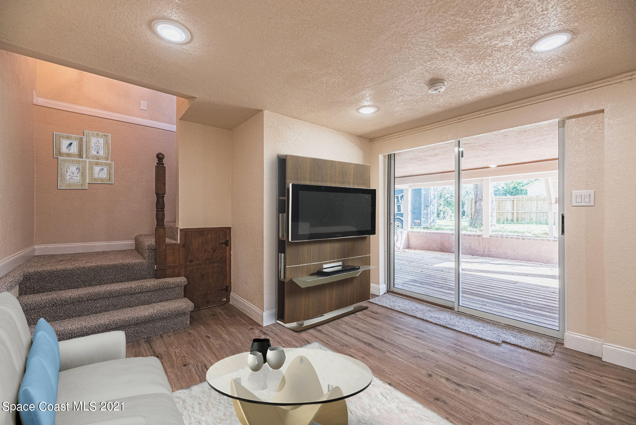 765 Garvey Road Palm Bay, FL 32908 - Photo 45 of 81 a living room with furniture and a flat screen tv