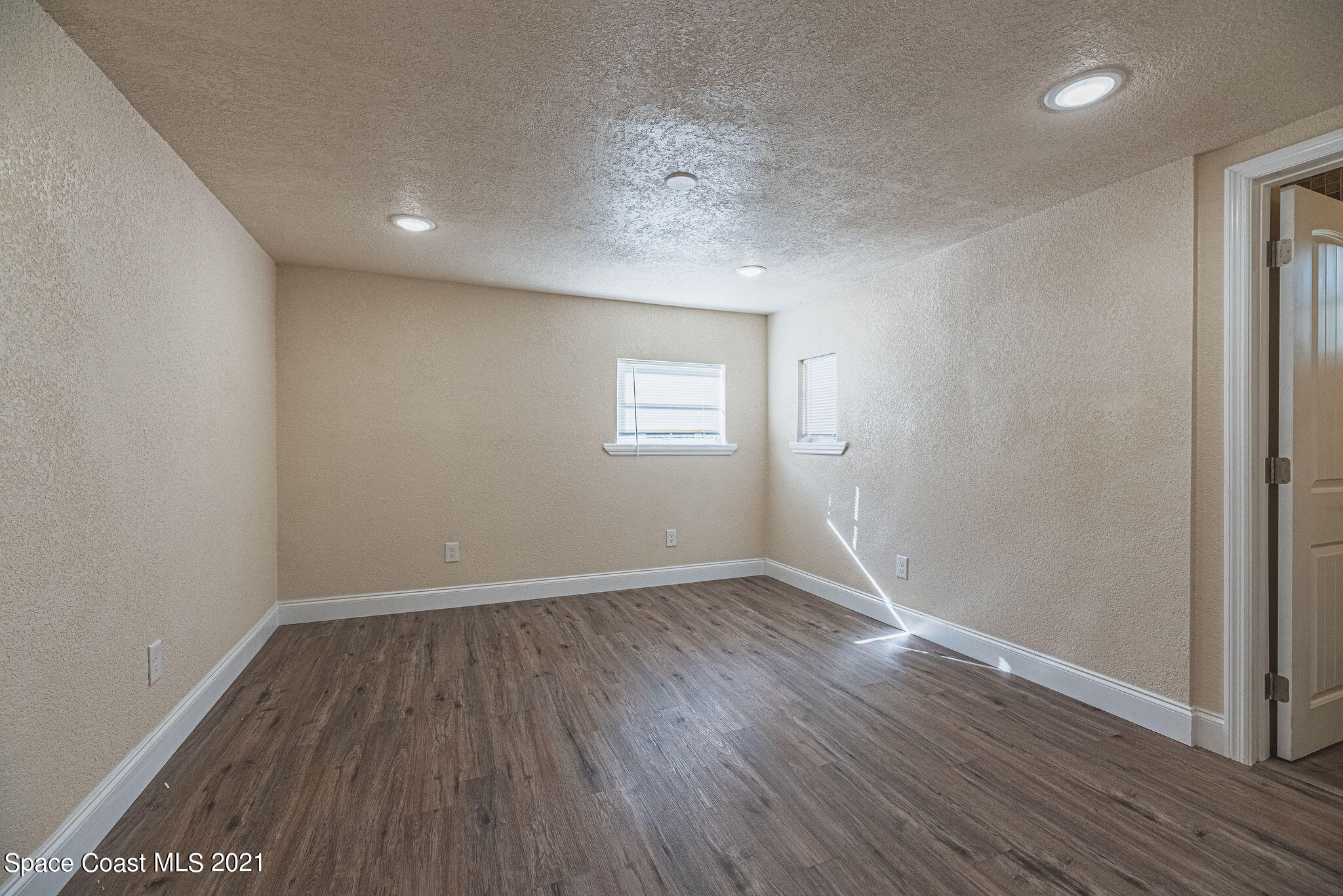 765 Garvey Road Palm Bay, FL 32908 - Photo 54 of 81 an empty room with wooden floor and windows
