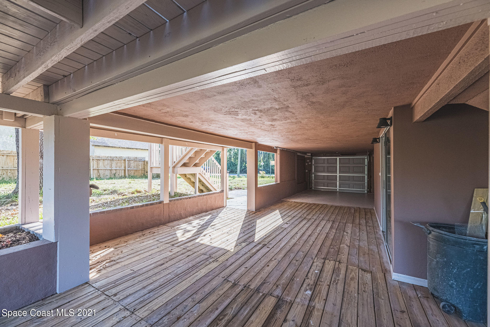 765 Garvey Road Palm Bay, FL 32908 - Photo 62 of 81 a view of an empty room with wooden floor and a window