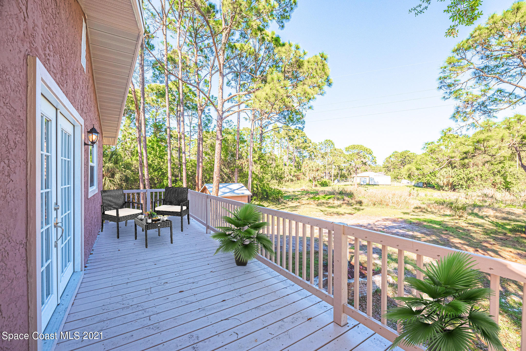 765 Garvey Road Palm Bay, FL 32908 - Photo 66 of 81 a view of a porch with furniture and wooden floor