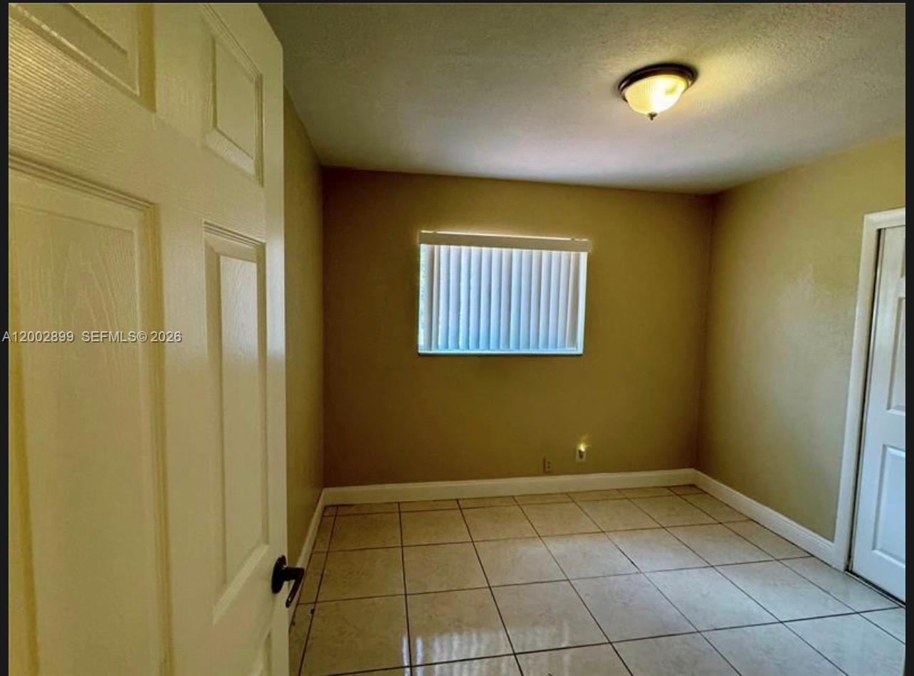 6471 Southwest 27th Street, Unit 1 & 2 Miramar, FL 33023 - Photo 13 of 29 a view of an empty room with a window
