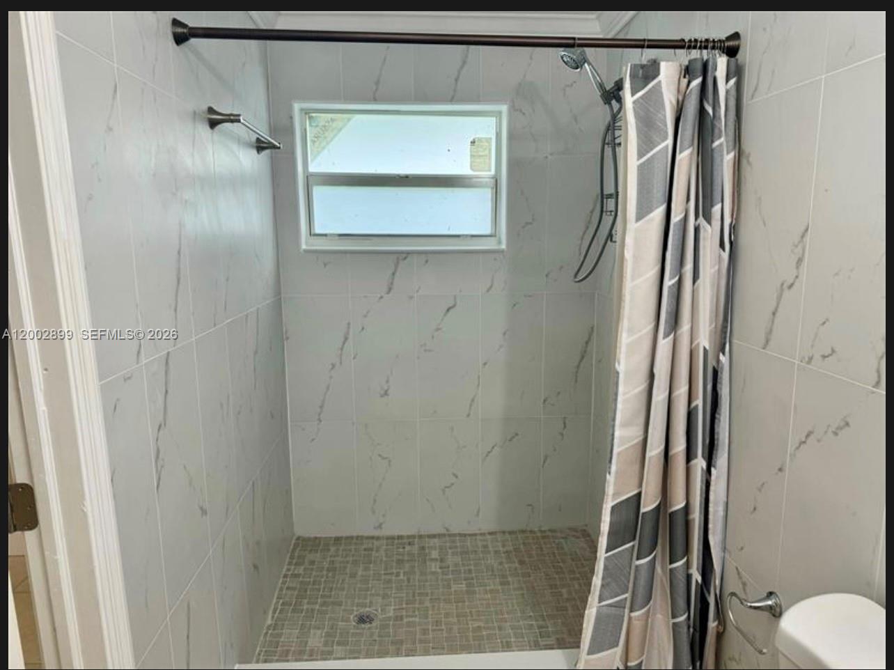 6471 Southwest 27th Street, Unit 1 & 2 Miramar, FL 33023 - Photo 8 of 29 a bathroom with a shower and a toilet