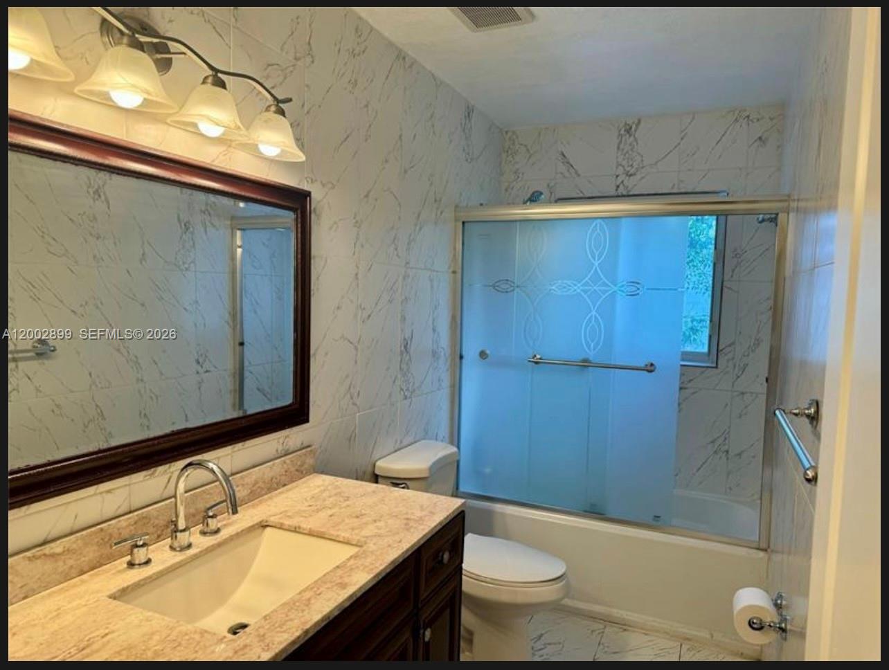 6471 Southwest 27th Street, Unit 1 & 2 Miramar, FL 33023 - Photo 10 of 29 a bathroom with a sink a toilet and shower
