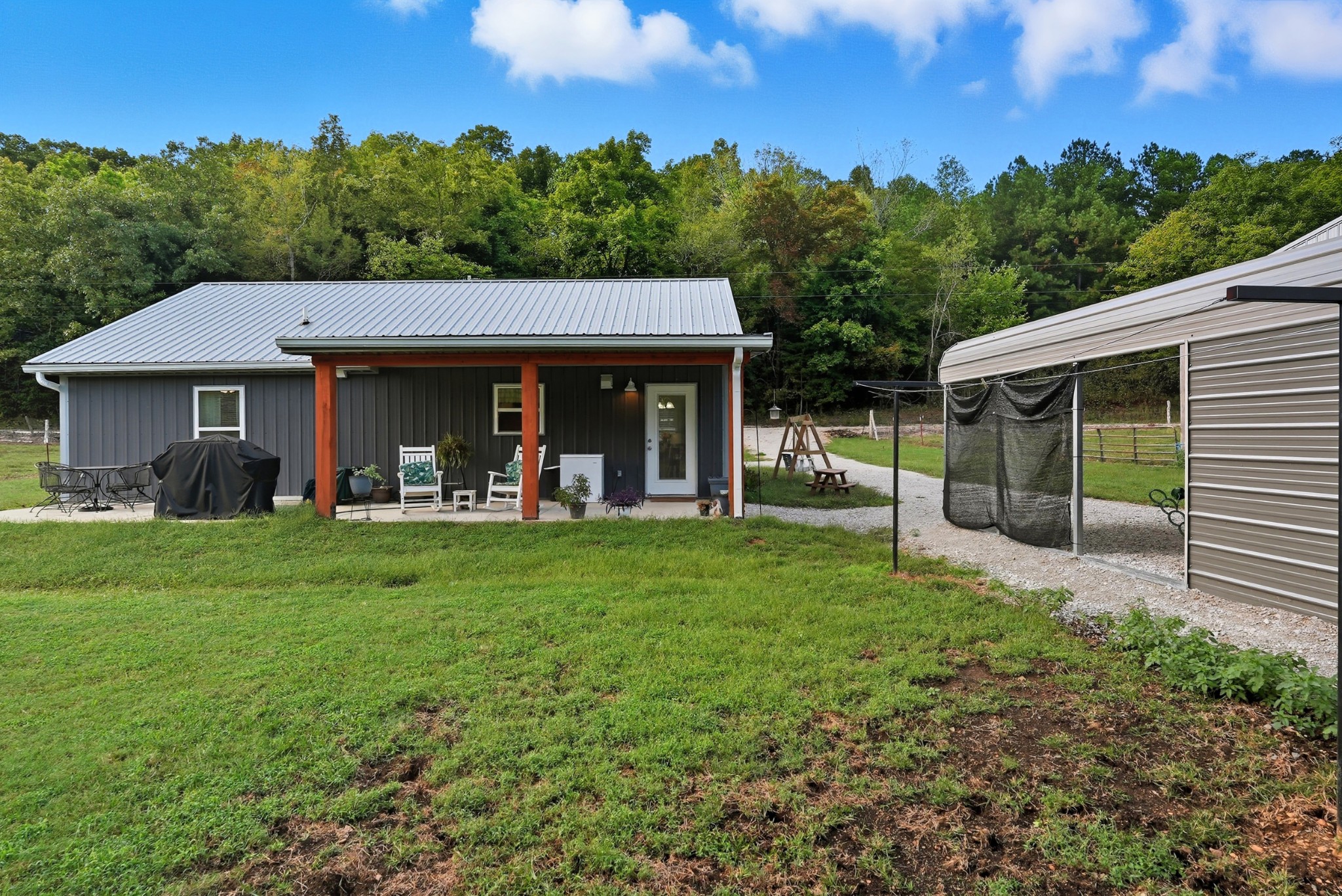 1215 Ennis Branch Road McEwen, TN 37101 - Photo 14 of 36 a view of a house with a backyard and porch