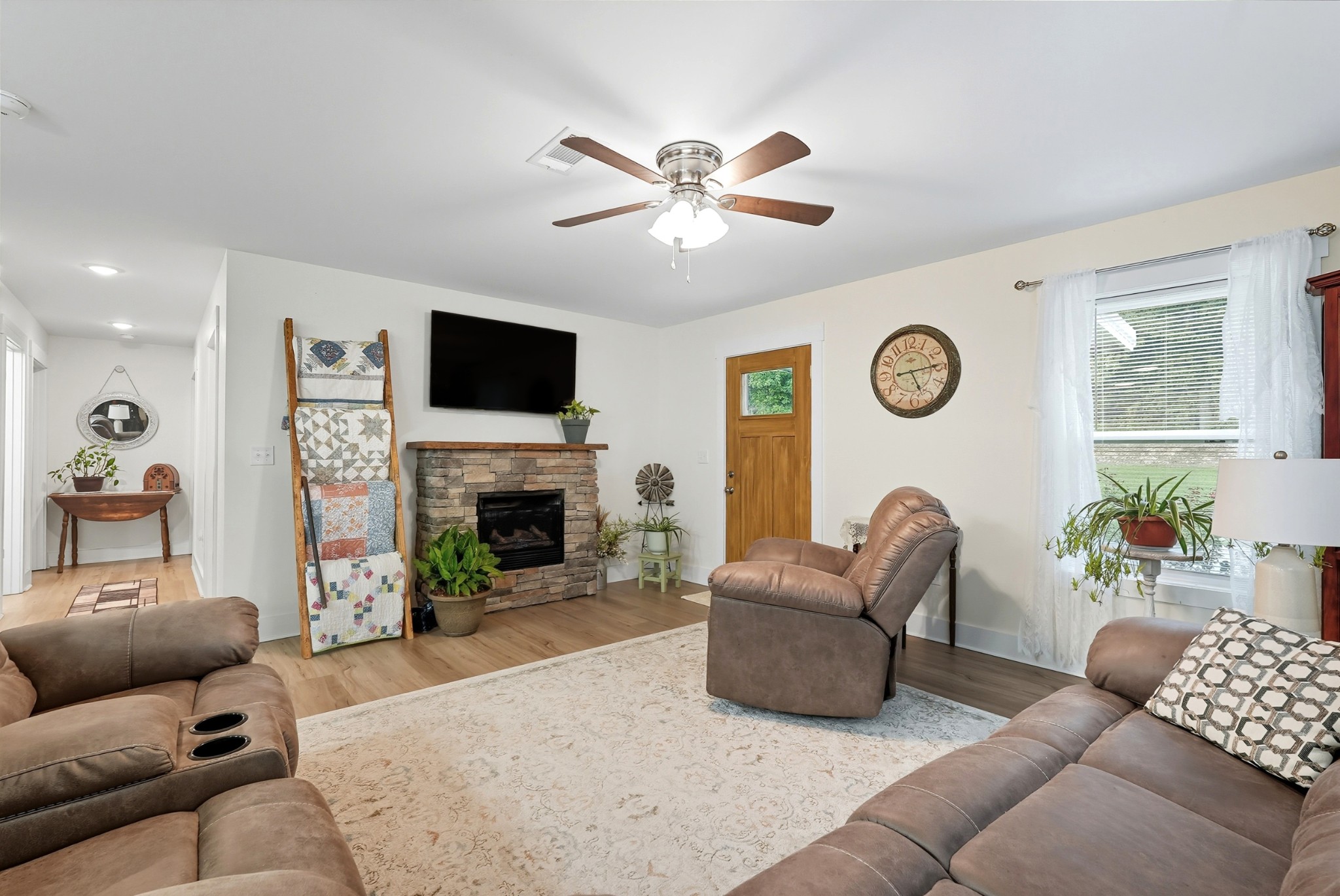 1215 Ennis Branch Road McEwen, TN 37101 - Photo 21 of 36 a living room with furniture a fireplace and a flat screen tv