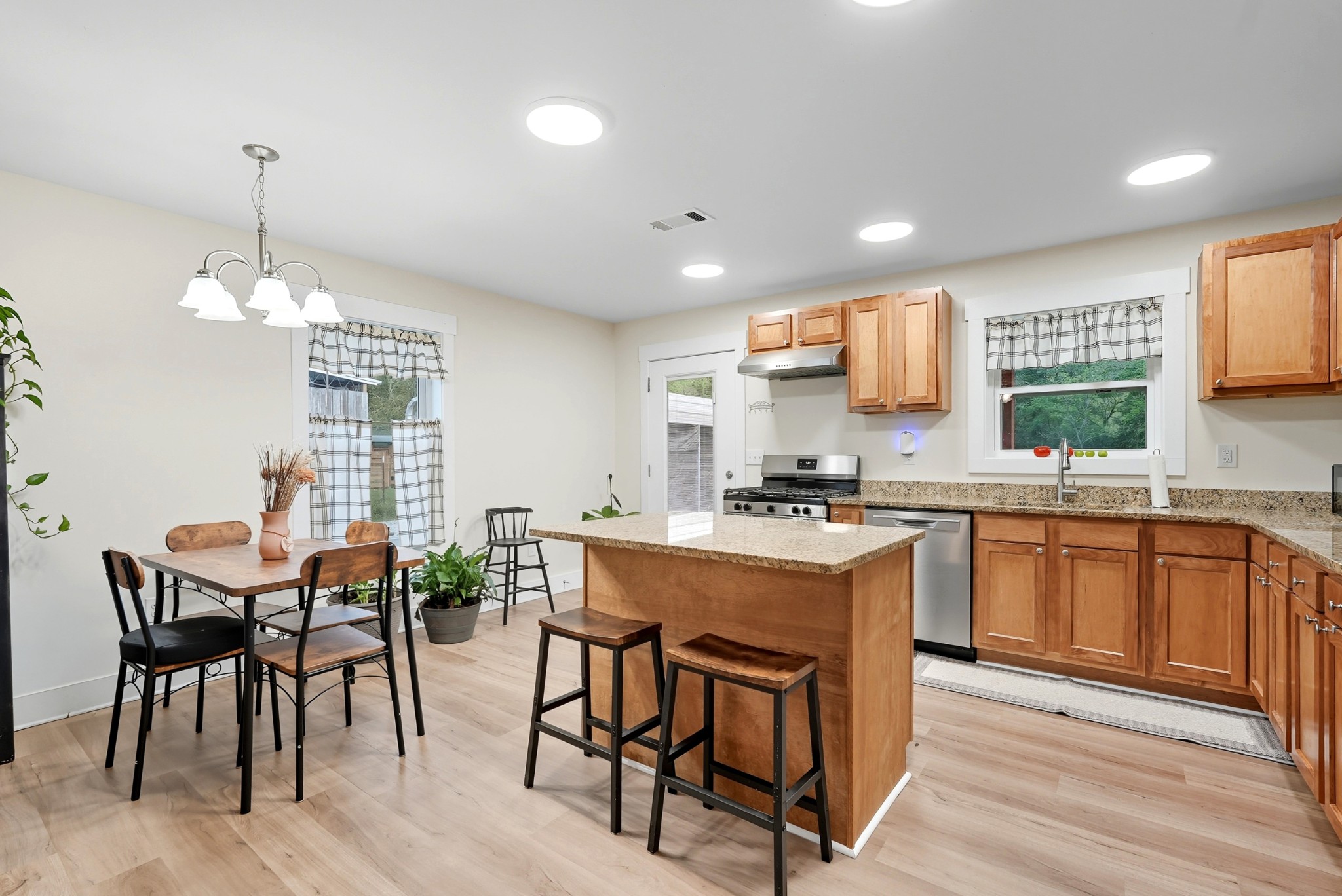 1215 Ennis Branch Road McEwen, TN 37101 - Photo 22 of 36 a kitchen with stainless steel appliances a table and chairs in it