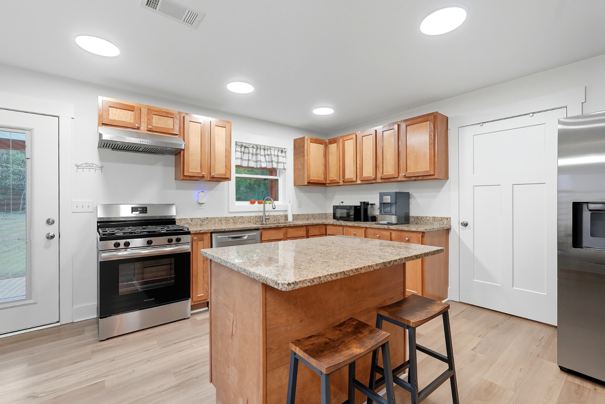1215 Ennis Branch Road McEwen, TN 37101 - Photo 25 of 36 a kitchen with a stove a sink and a refrigerator