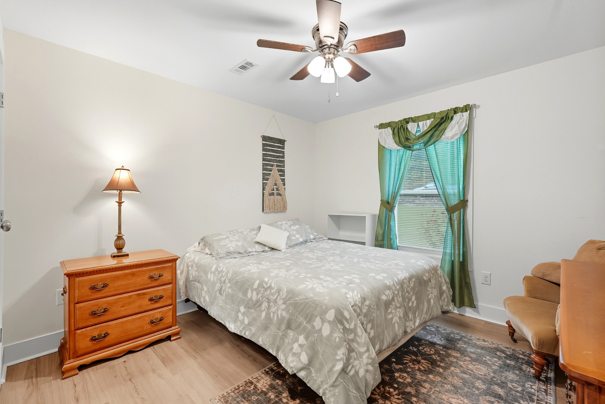 1215 Ennis Branch Road McEwen, TN 37101 - Photo 27 of 36 a bedroom with a bed a chandelier and a window