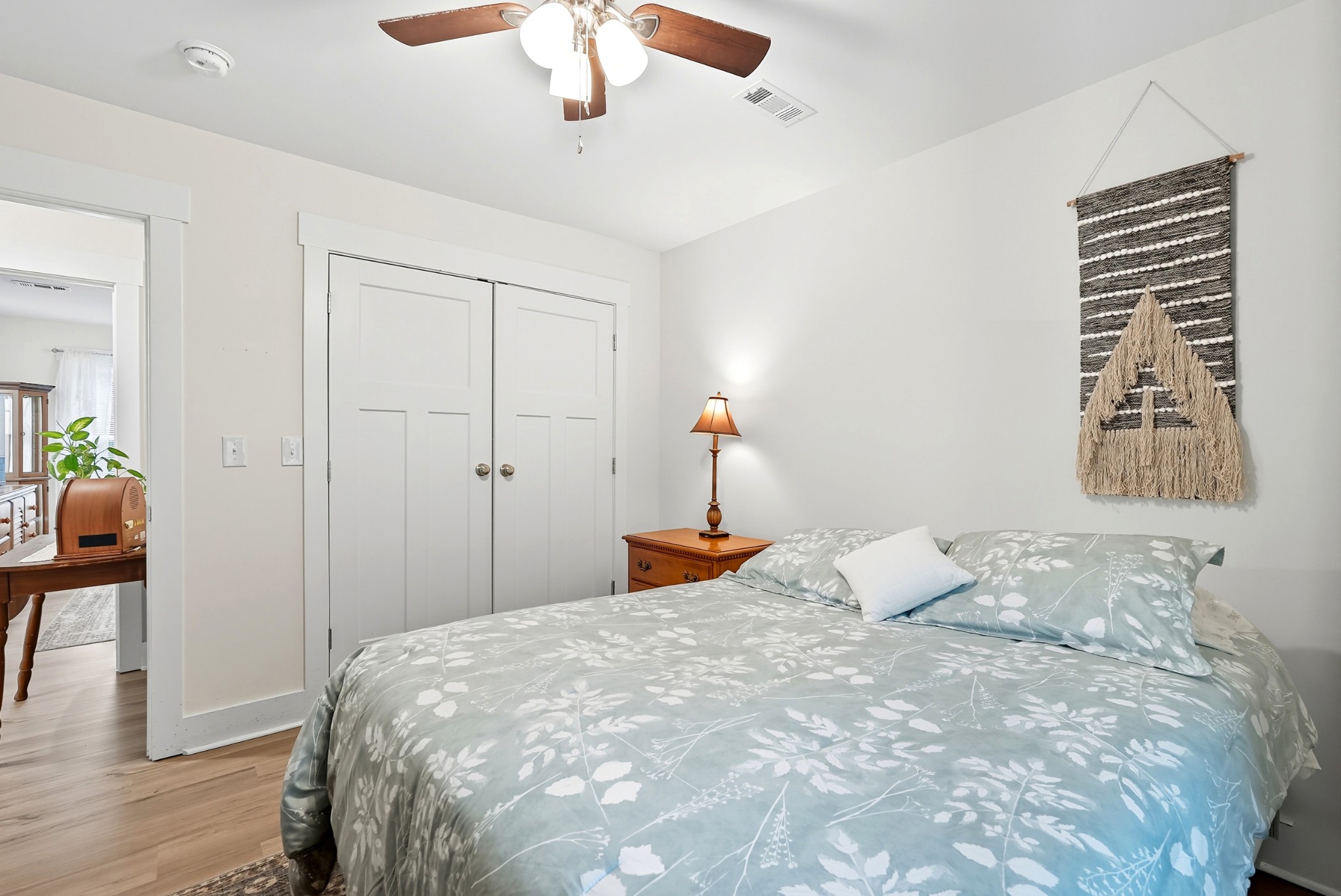 1215 Ennis Branch Road McEwen, TN 37101 - Photo 28 of 36 a bedroom with a large bed and a chandelier