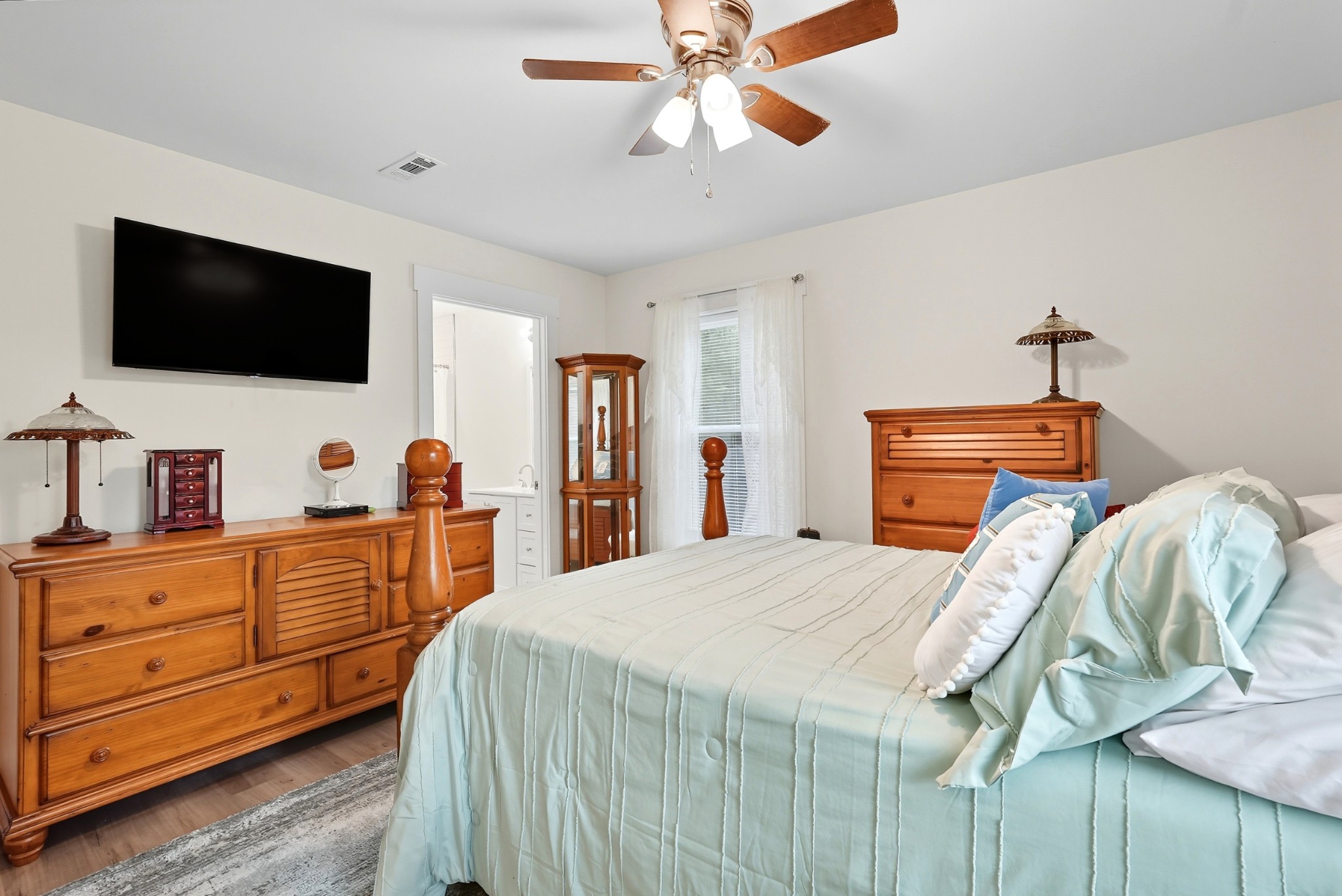 1215 Ennis Branch Road McEwen, TN 37101 - Photo 30 of 36 a bedroom with a bed and a flat screen tv