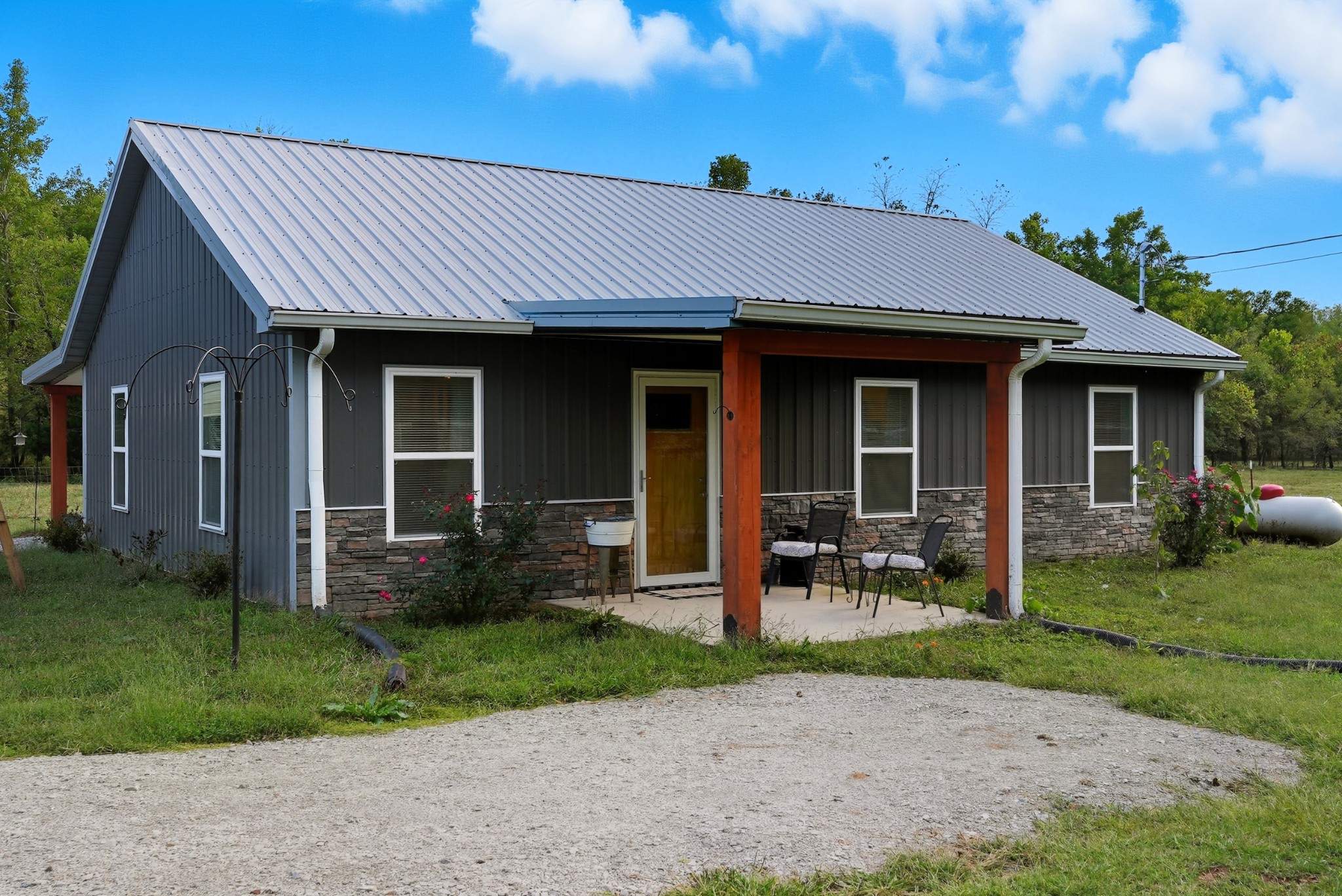 1215 Ennis Branch Road McEwen, TN 37101 - Photo 4 of 36 a front view of a house with garden and porch
