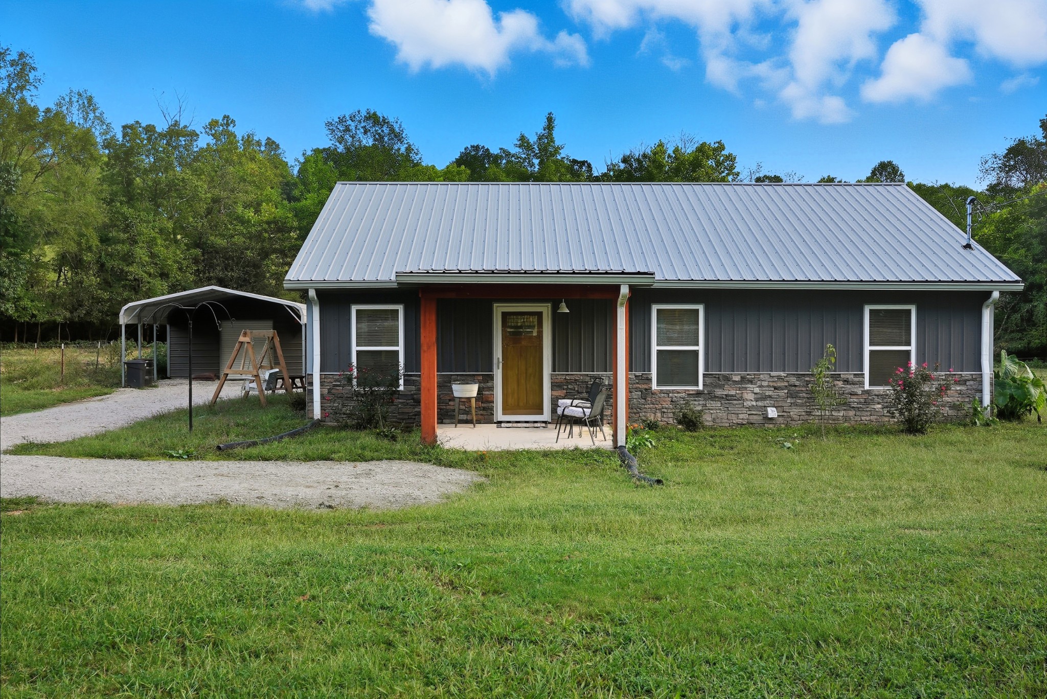 1215 Ennis Branch Road McEwen, TN 37101 - Photo 9 of 36 a front view of a house with a garden and porch