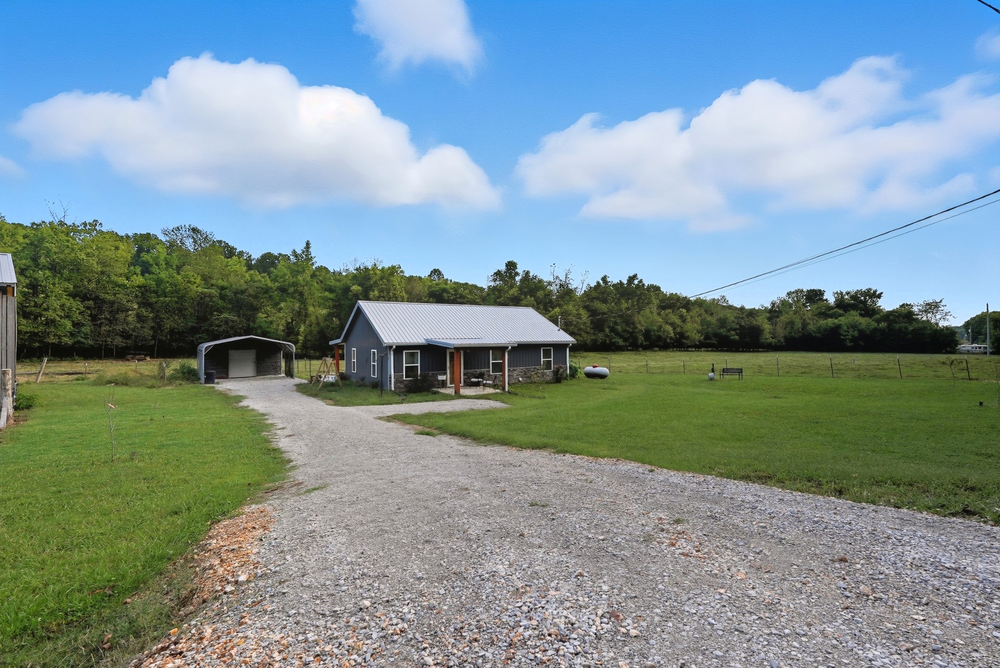 1215 Ennis Branch Road McEwen, TN 37101 - Photo 10 of 36 a view of a garden with a bench in front of the house
