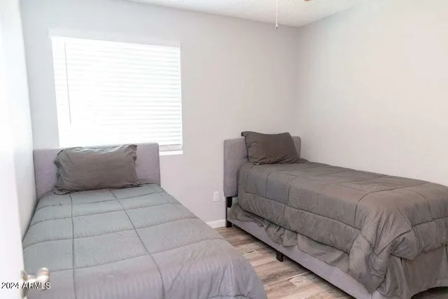 a spacious bedroom with a bed and a window