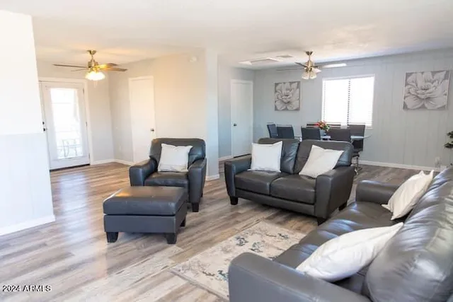 a living room with furniture and a mirror