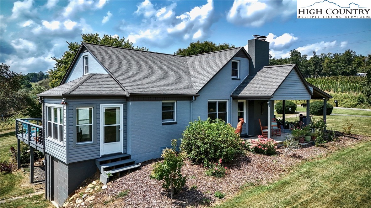1046 J E Gentry Road Laurel Springs, NC 28644 - Photo 1 of 49 a front view of house with yard and trees
