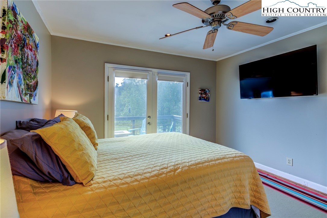 1046 J E Gentry Road Laurel Springs, NC 28644 - Photo 18 of 49 a bedroom with a bed and a flat screen tv