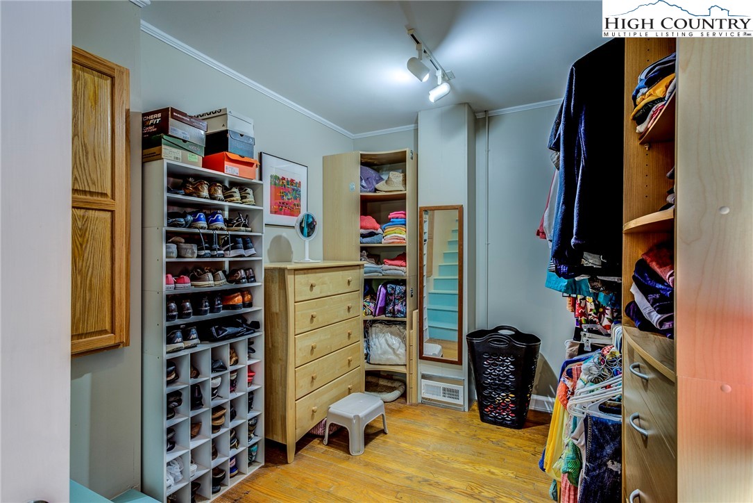 1046 J E Gentry Road Laurel Springs, NC 28644 - Photo 19 of 49 a view of walk in closet with clothes and shoes