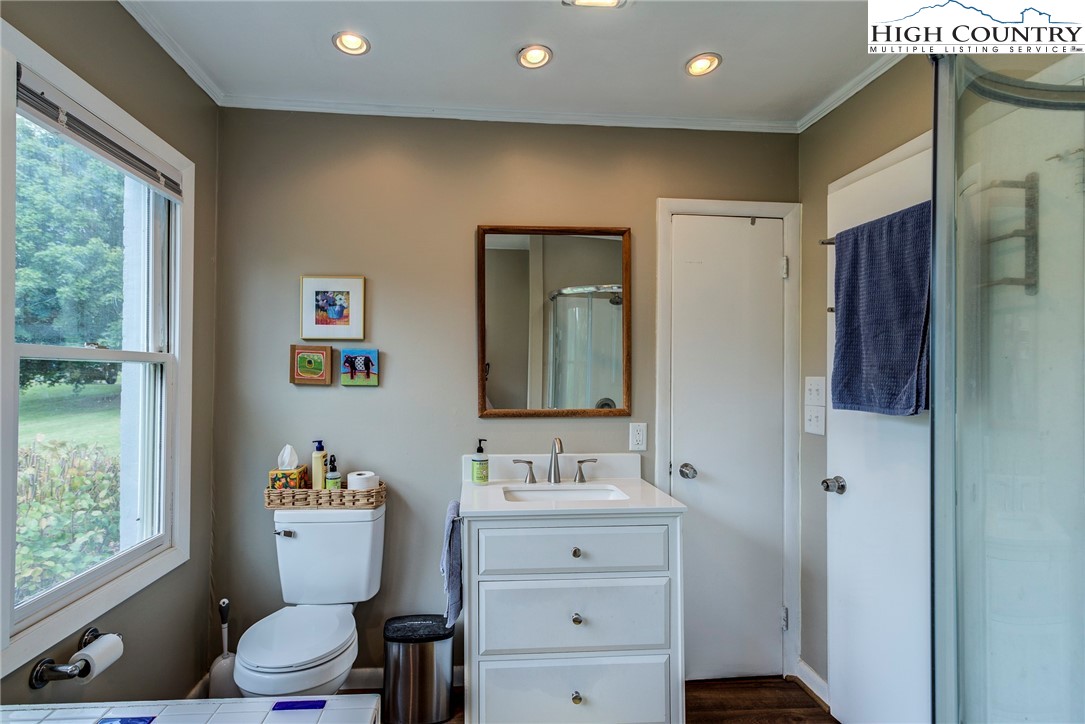 1046 J E Gentry Road Laurel Springs, NC 28644 - Photo 20 of 49 a bathroom with a toilet sink and mirror